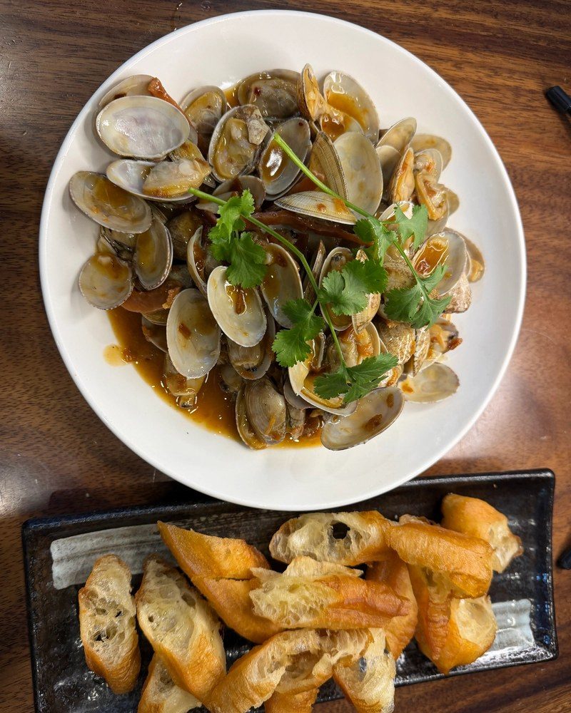 Clams stir-fried in XO sauce with coriander, served with fried bread sticks