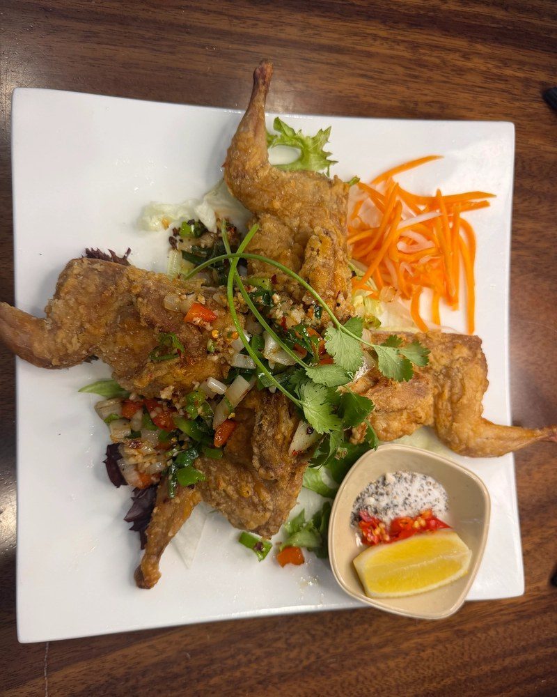 Crisp salt and pepper quail topped with chilli, onion and coriander, with a salt, pepper and lemon dip